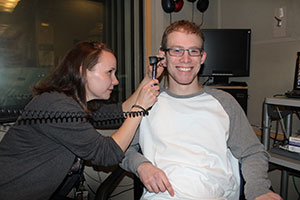 Researcher examines a patient's ear