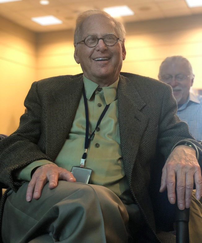 Richard Chadwick smiles as he listens to talks from mentees and collaborators at his April 10, 2019, retirement symposium.