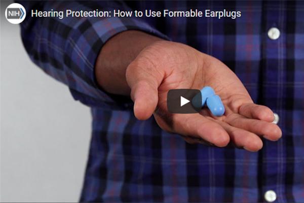 A man demonstrating the correct way to use formable earplugs to help prevent noise-induced hearing loss.