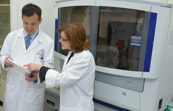 Wade Chien, M.D.; and Lisa L. Cunningham, Ph.D., discuss use of next-generation sequencing in the NIDCD Clinical Genomics Core Facility.