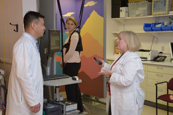 Former Chief of Audiology Carmen Brewer Ph.D. (right),
and Wade Chien, M.D. (left), discuss the use of
posturography for the study of balance disorders.