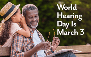 World Hearing Day is March 3. A daughter whispering into her father's ear.