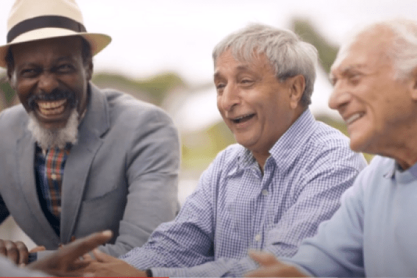 Three senior adults talking and laughing.