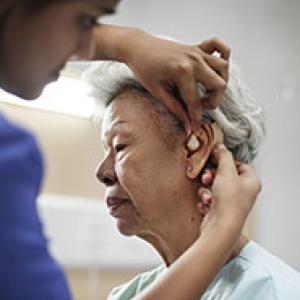 A woman having her hearing aid fit check.